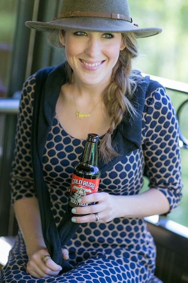 Eden Passante drinking Gold Rush beer on a train in Alaska 