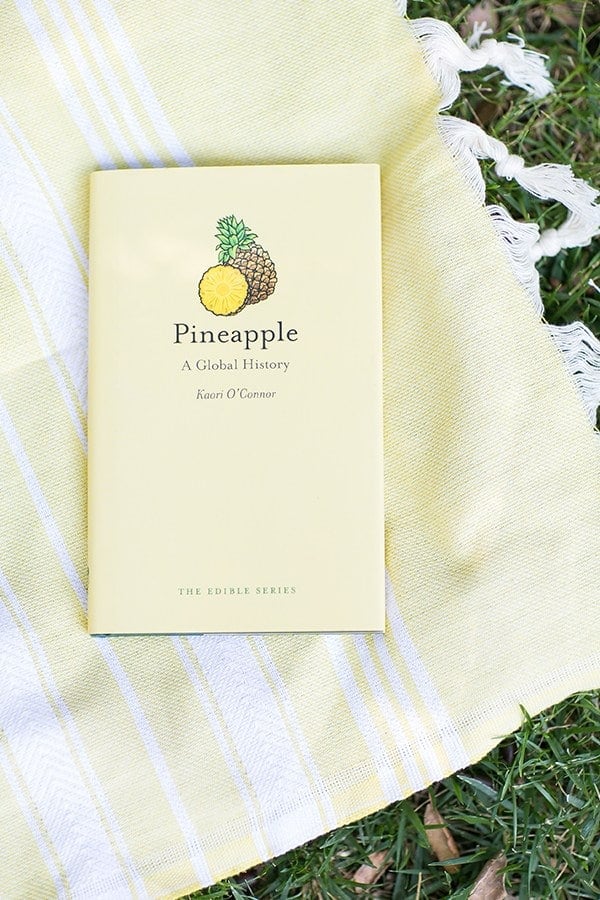 Pineapple history book on a yellow towel.