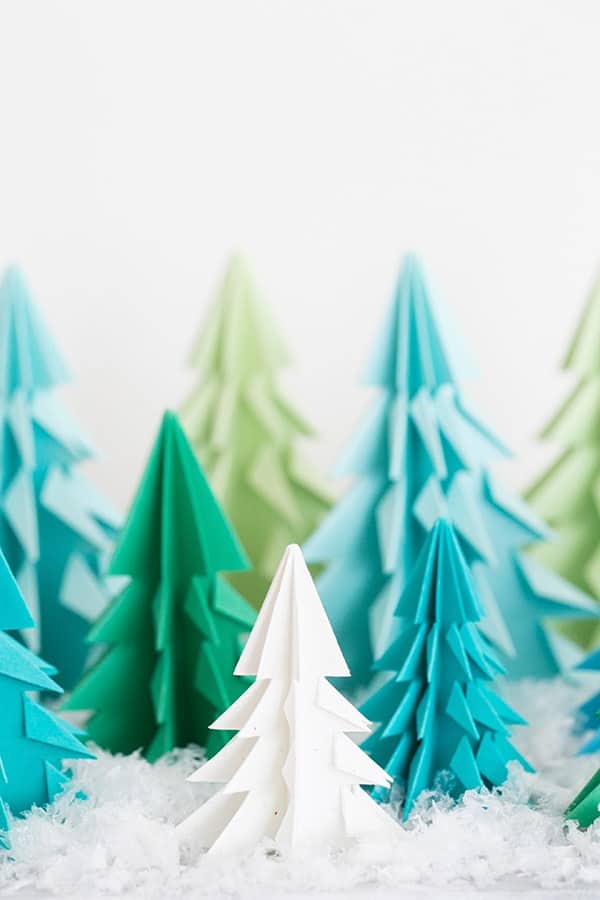 Paper origami trees on a table with fake snow. - origami christmas tree, origami christmas