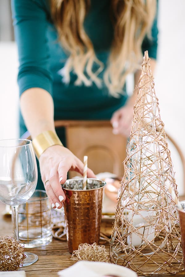 eden placing copper tumbler on a table 