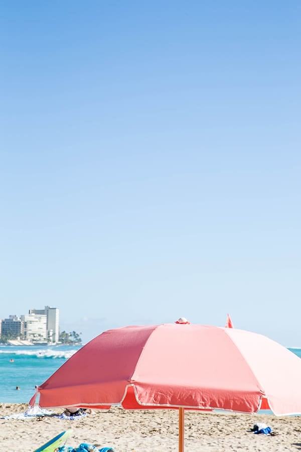 Pink umbrella on the beach.