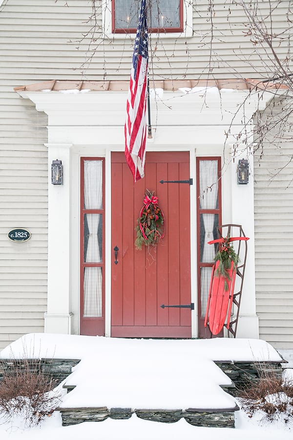 Charming red door with flag and sled 