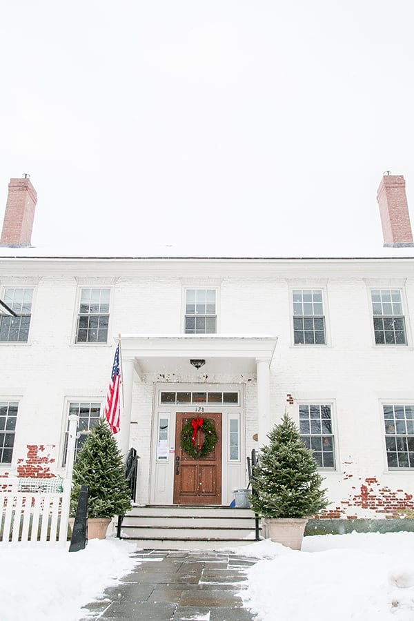 White brick house with beautiful wreath in Stowe