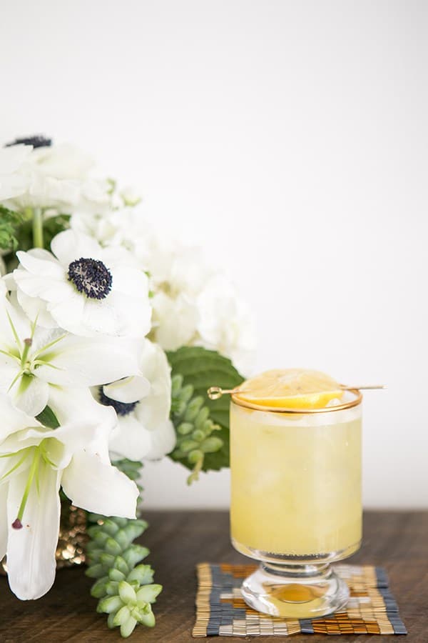 Spiked lemonade with coaster and flowers for an Oscar party