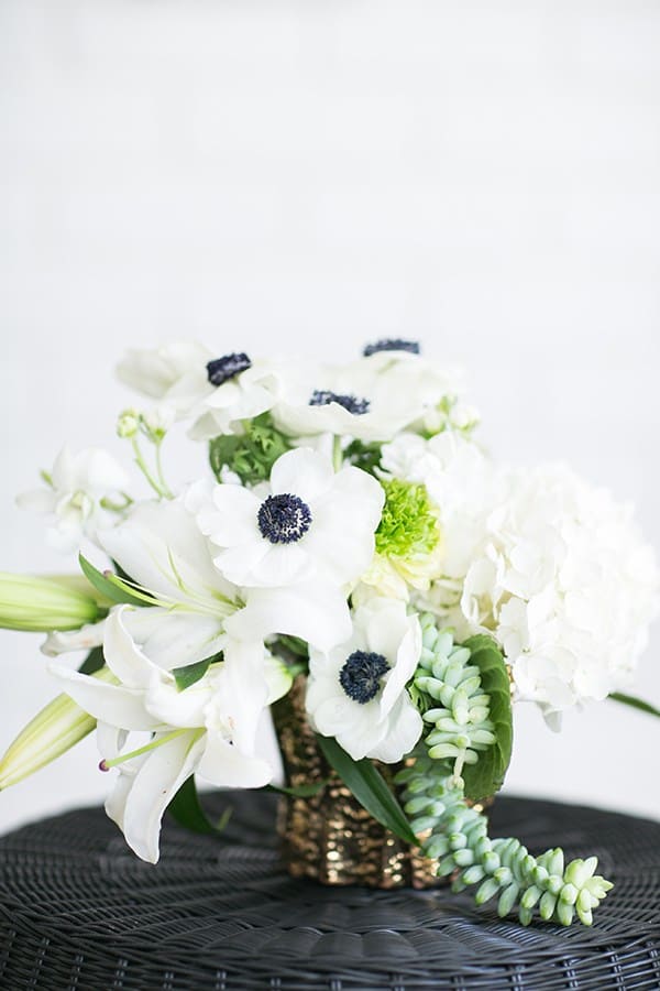 White flowers with black middle and green.