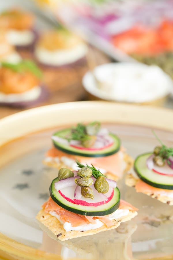 Oscar party canapés with salmon, cucumber, capers and onions.