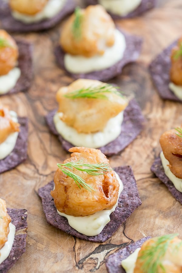 Twist on fish n chips with fried fish on a blue corn chip.