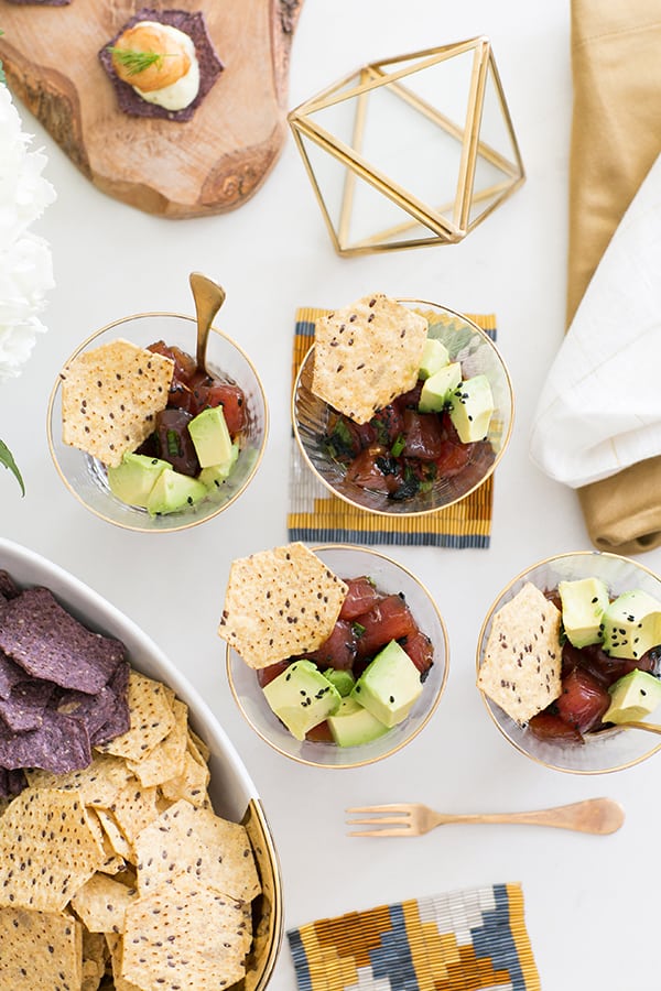 Ahi poke in small bowls with chips for an Oscar party.