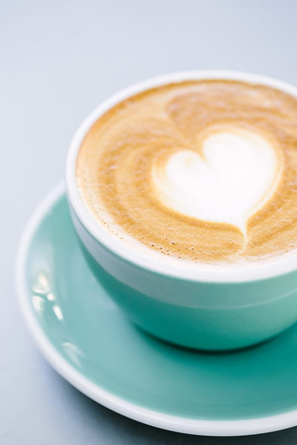 Latte in green cup with a heart