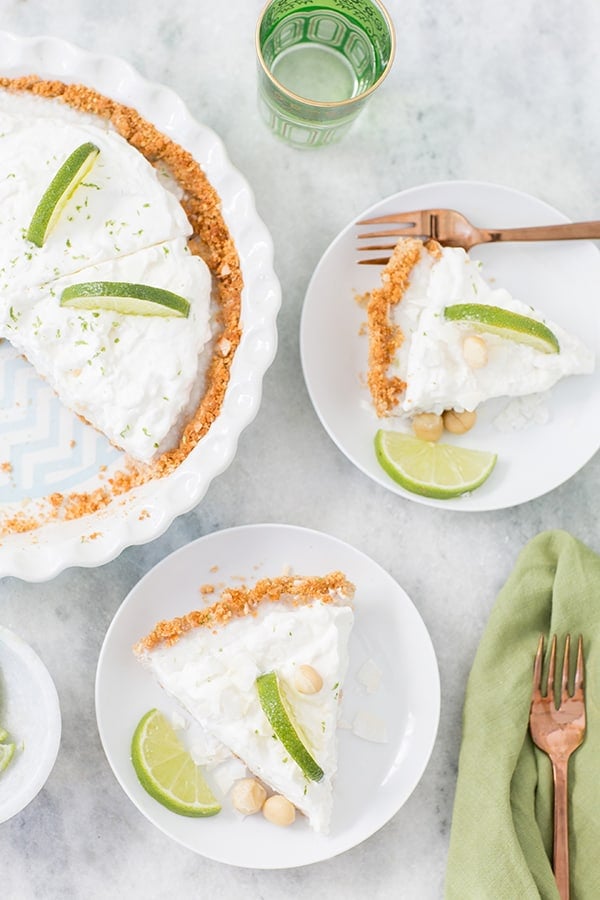 Coconut key lime pie slice on a marble table.