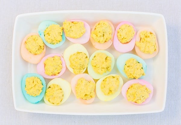 Colorful hard deviled eggs in a tray
