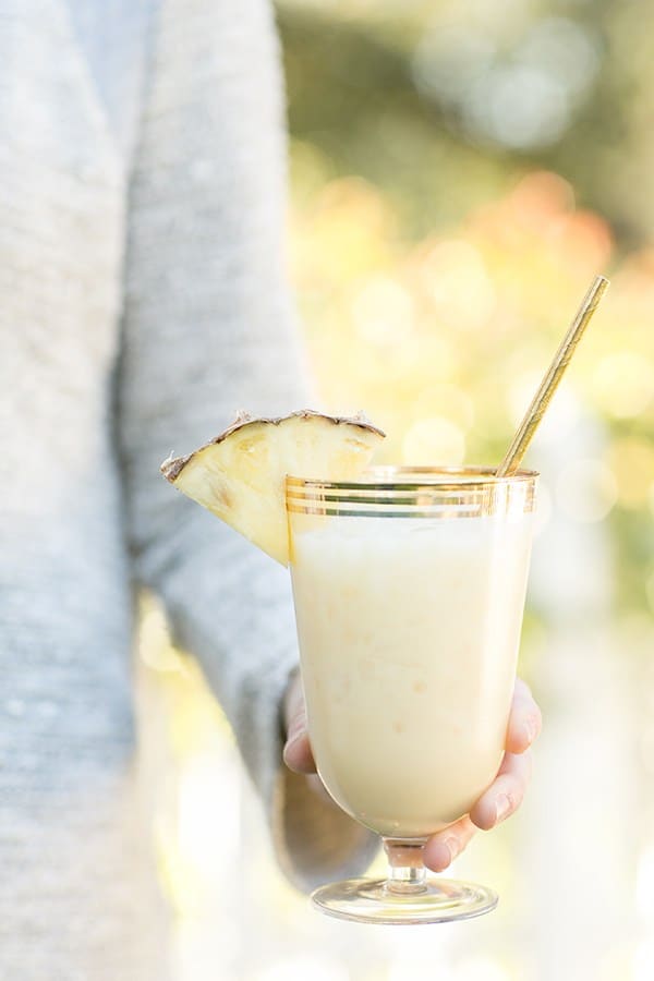 Girl holding a pina colada 