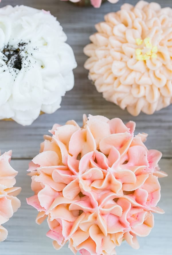 close up shot of floral cupcake - vanilla frosting