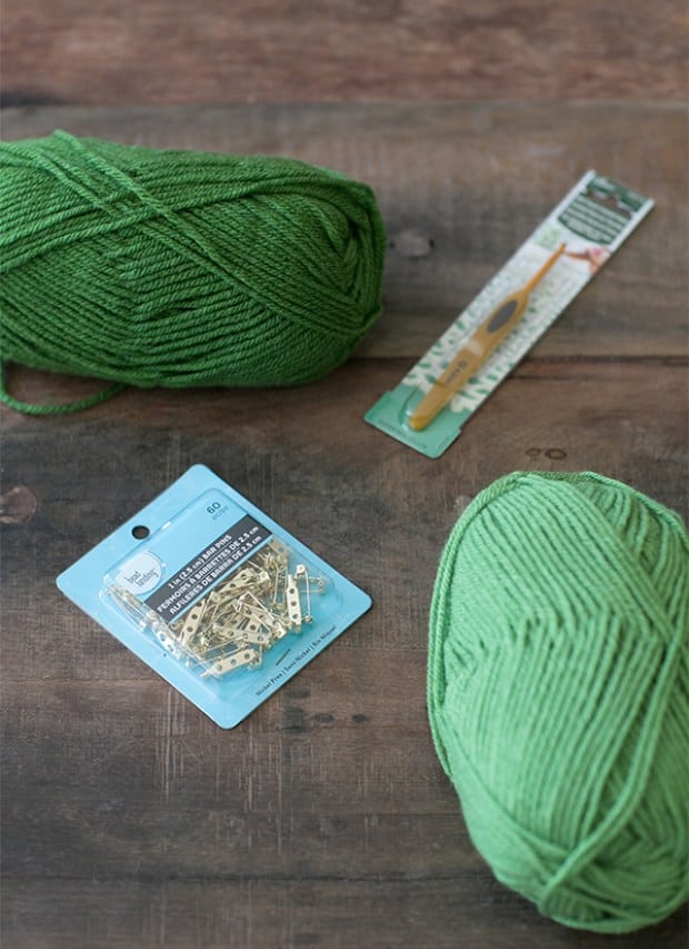 green yarn, pins and crochet hook