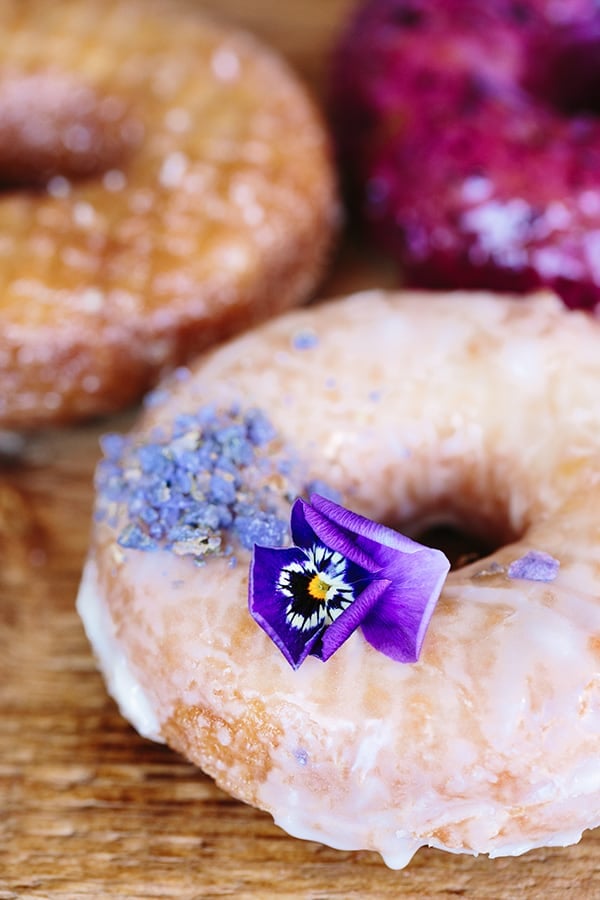picture of glazed doughnut with edible flower.