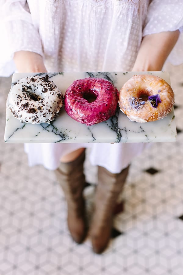 Holding a tray of doughnuts at Sidecar doughnuts