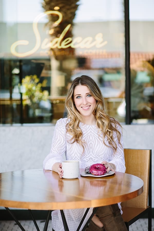 Eden Passante sitting at Sidecar Doughnuts 