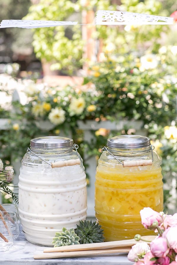 Horchata and Pineapple Agua Fresca in large jugs.