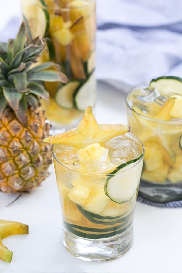 Sparkling sake in a glass with cucumbers and a sliced starfish 