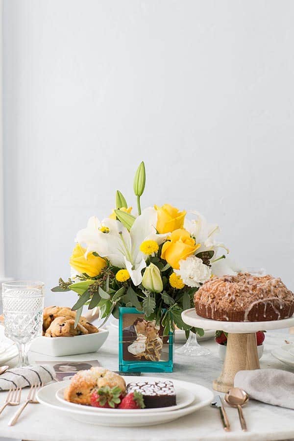 flower arrangement on a table with coffee cake and Mother's Day ideas.