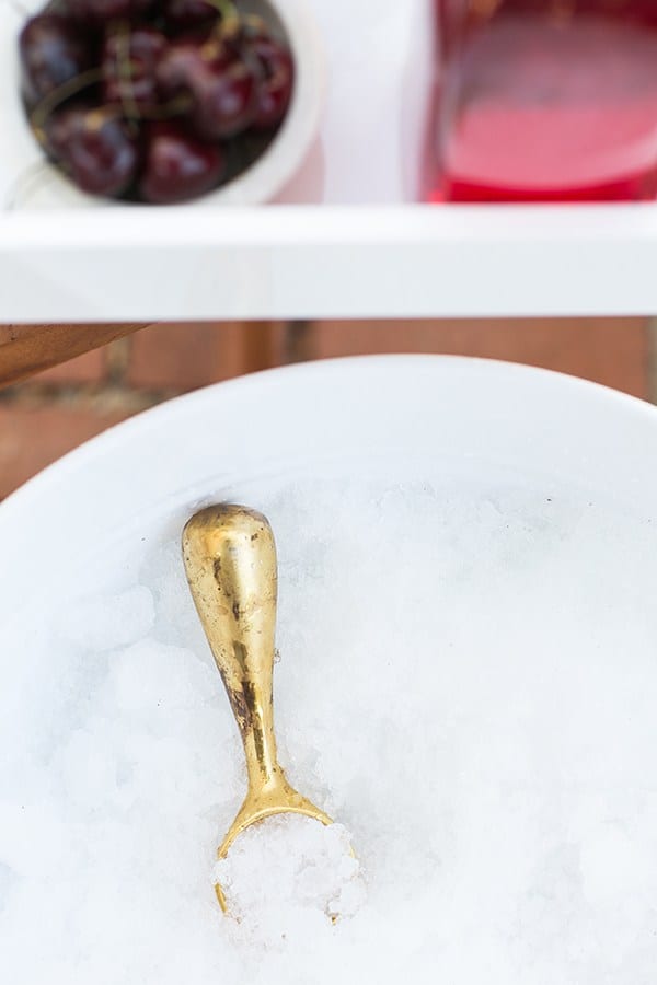 Bucket of ice with a brass ice cream scooper.