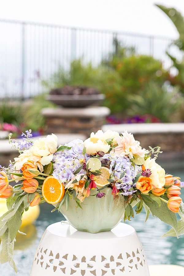 Flower arrangement on a garden stool at a pool party