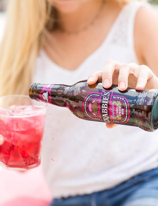 Girl pouring ginger beer into a glass