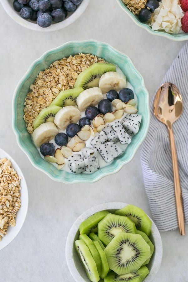 Yogurt bowl with rows of fruit.