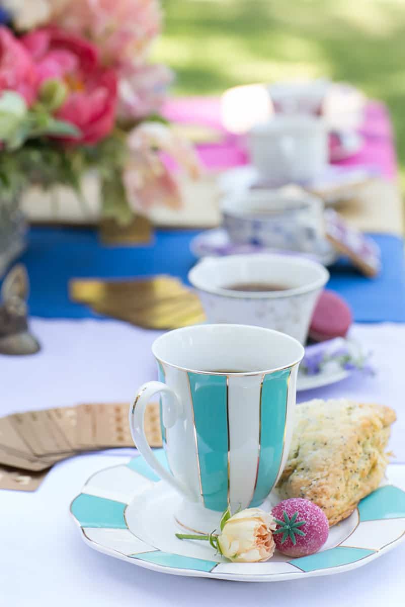 Different vintage tea cups and tea desserts,