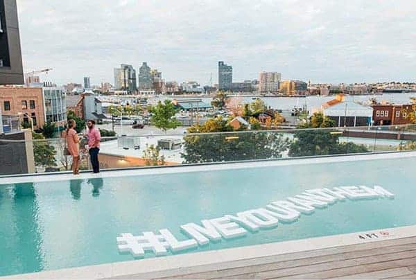 Large pool letters floating in a pool over looking the city 