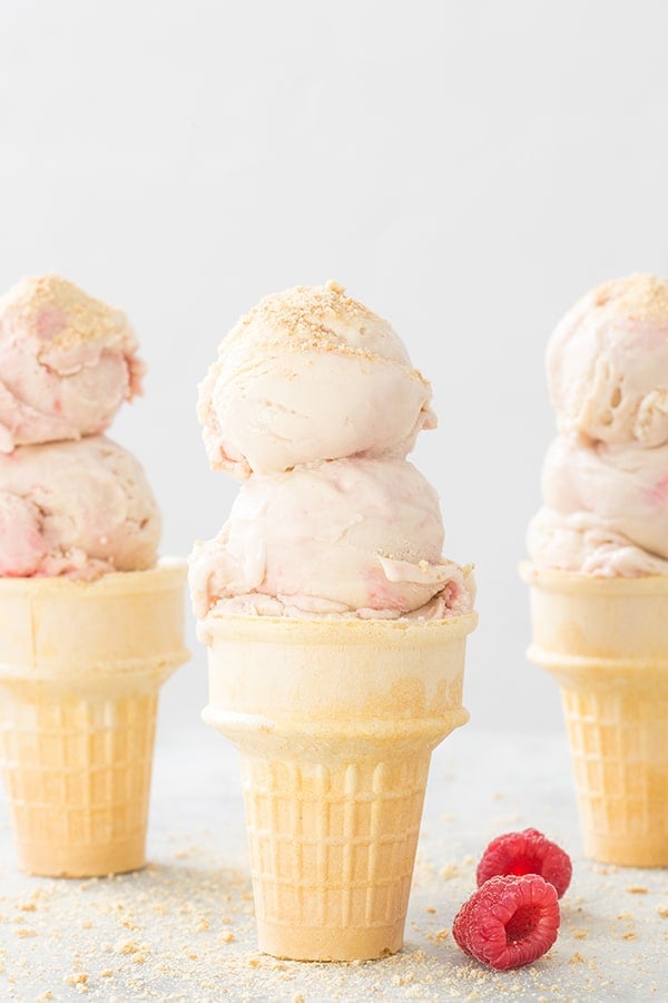 Three ice cream cones with raspberry swirl cheesecake ice cream  - raspberry cheesecake ice cream