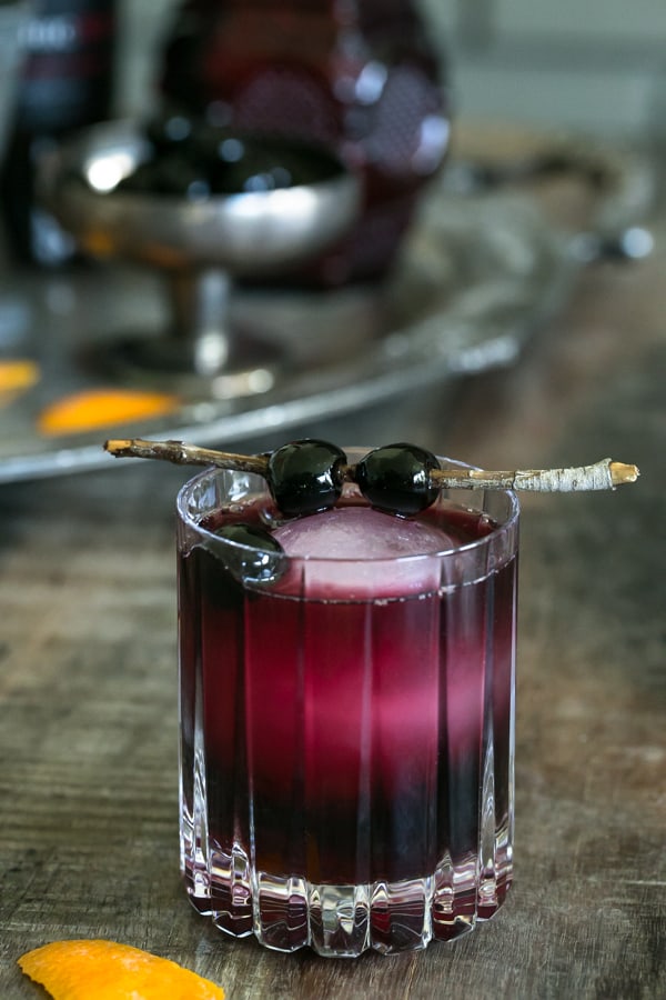 A red moon over manhattan cocktail garnished with cherries