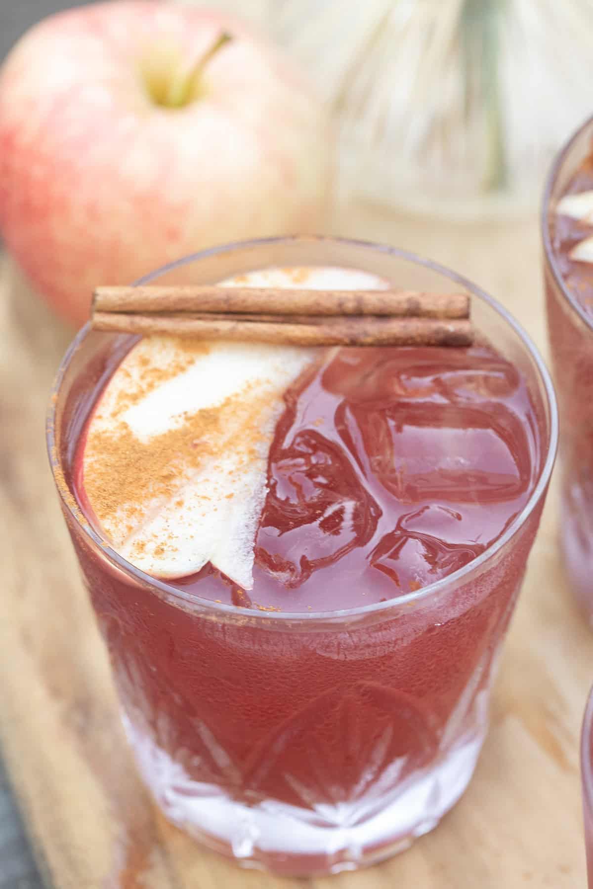 Apple pie sangria with thinly sliced apples and cinnamon sticks.