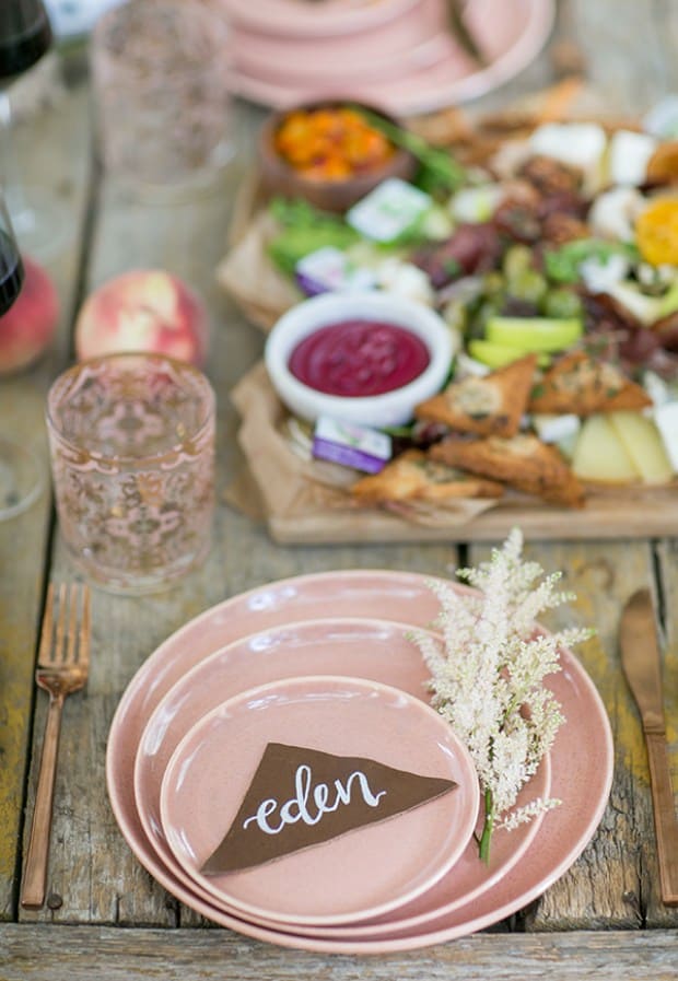 plates on a table with charcuterie board in the background - cheese board