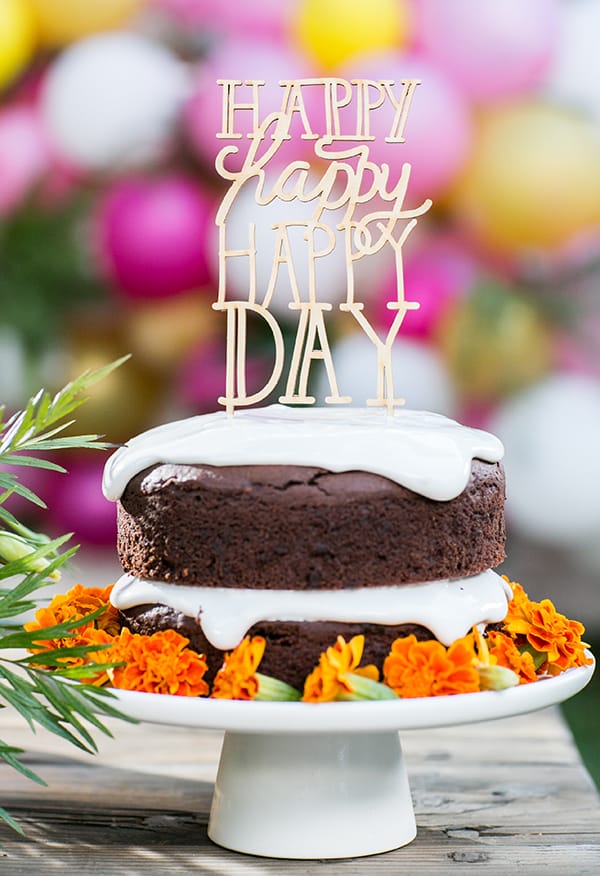 Gluten free birthday cake with happy happy happy day sign