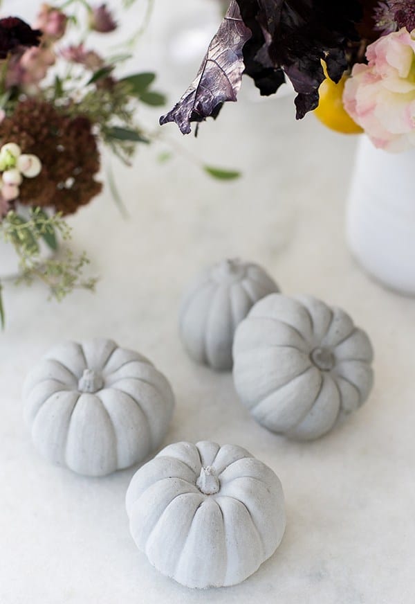 4 pumpkin decorations on a table - pumpkin pail