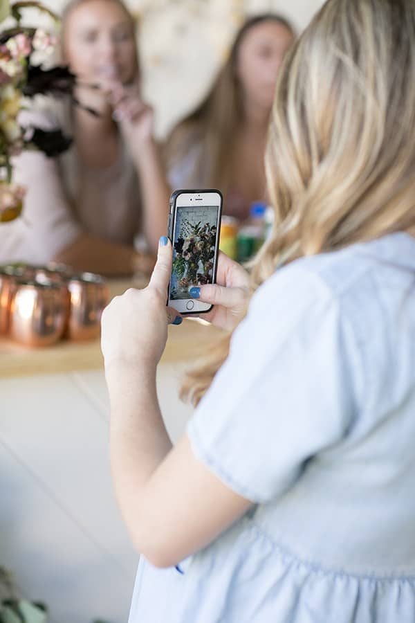 Eden Passante taking a photo of her baby shower - fall baby shower, baby shower theme