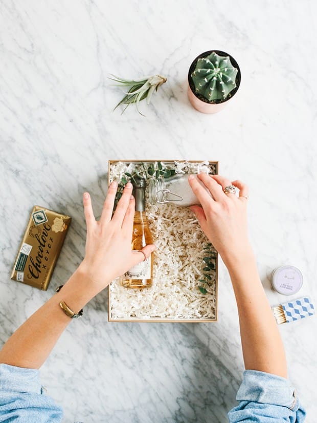 Hands showing how to make a bubble bath gift box