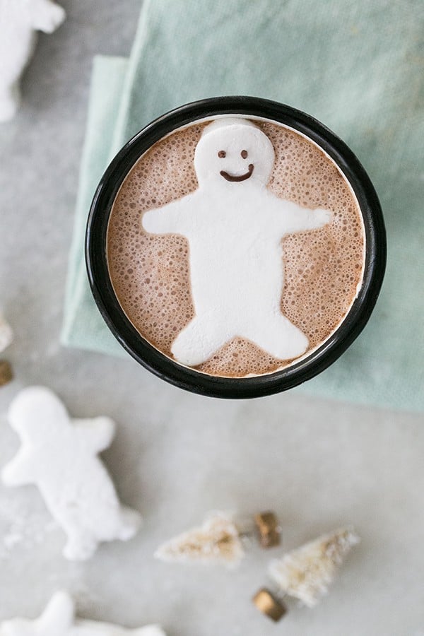 Little homemade gingerbread marshmallow man in a cup of hot chocolate.