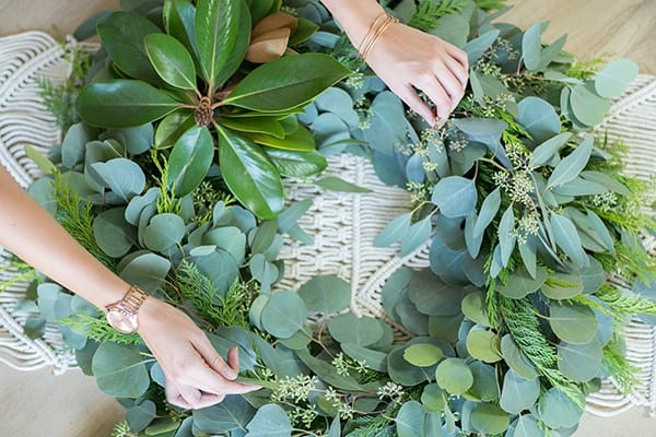 hands assembling a wreath