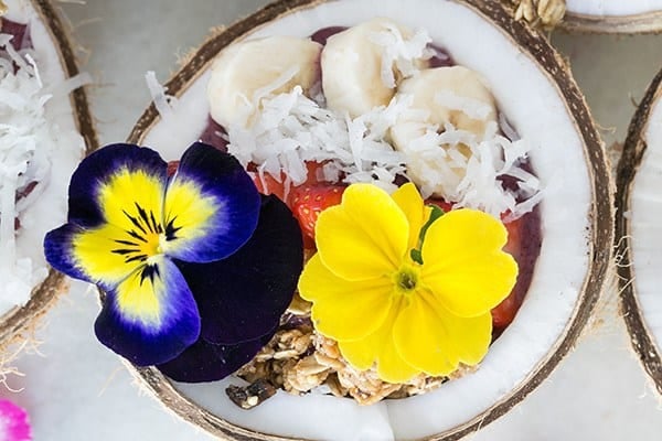 Acai bowl with flowers over the top.