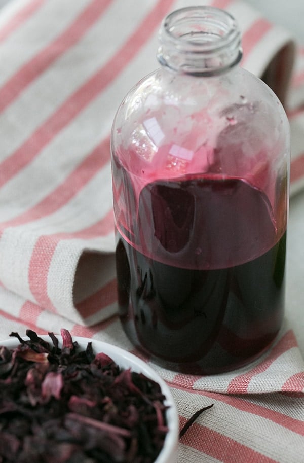 side shot of hibiscus simple syrup in glass jar