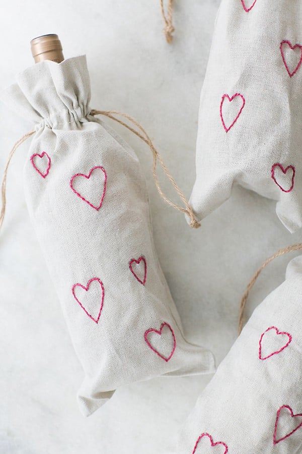 DIY wine bags with rosé inside and pink hearts.