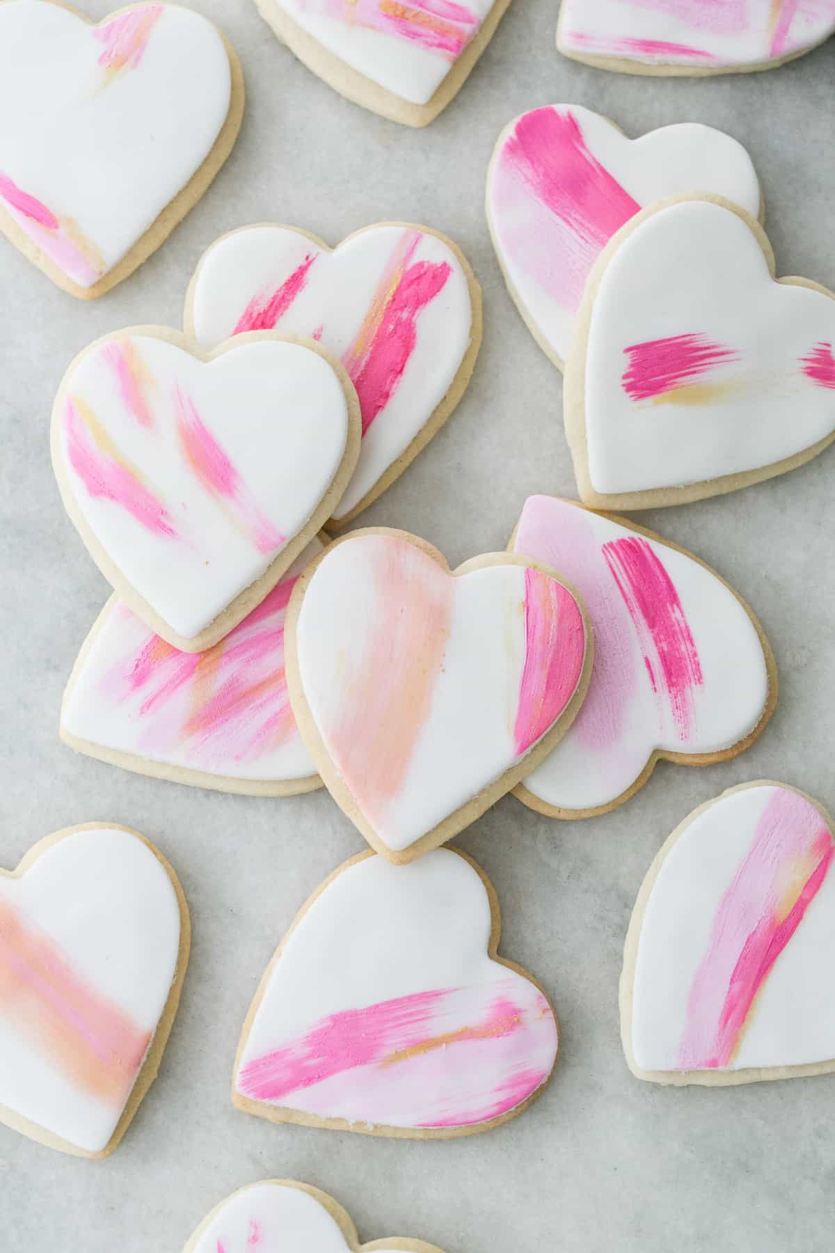 heart shaped frosted sugar cookies on a table 