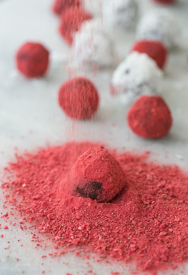 coconut truffles being dusted with strawberry dust