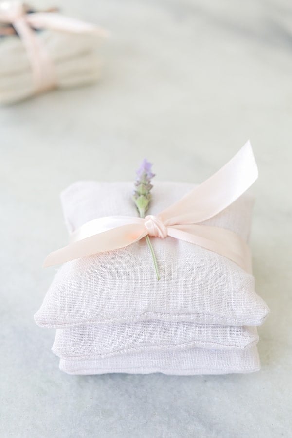 Charming DIY Lavender Sachets made with pink linen fabric and tied with a bow.