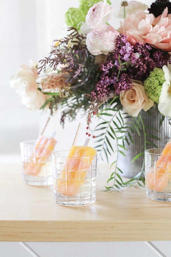 Striped popsicles in a cocktail glass with Champagne. 