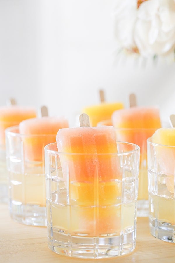 Striped greyhound popsicles in a glass with champagne 