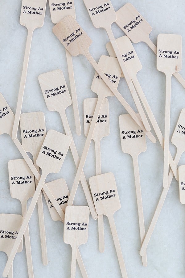 Wooden stir sticks that say strong as a mother