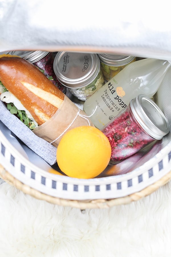 Picnic food inside a picnic basket. 